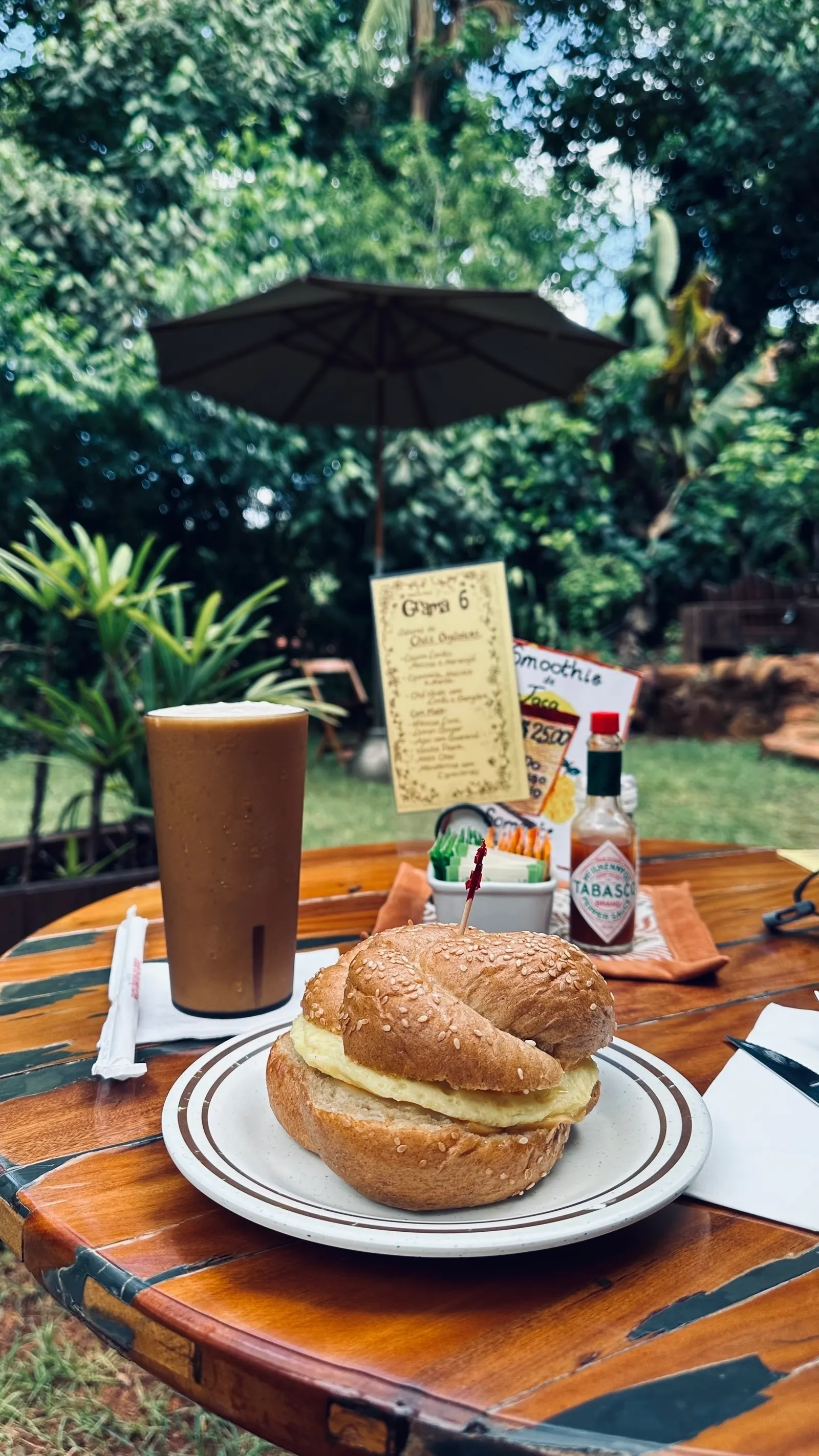 Iced coffee and a sandwich at an outdoor café table